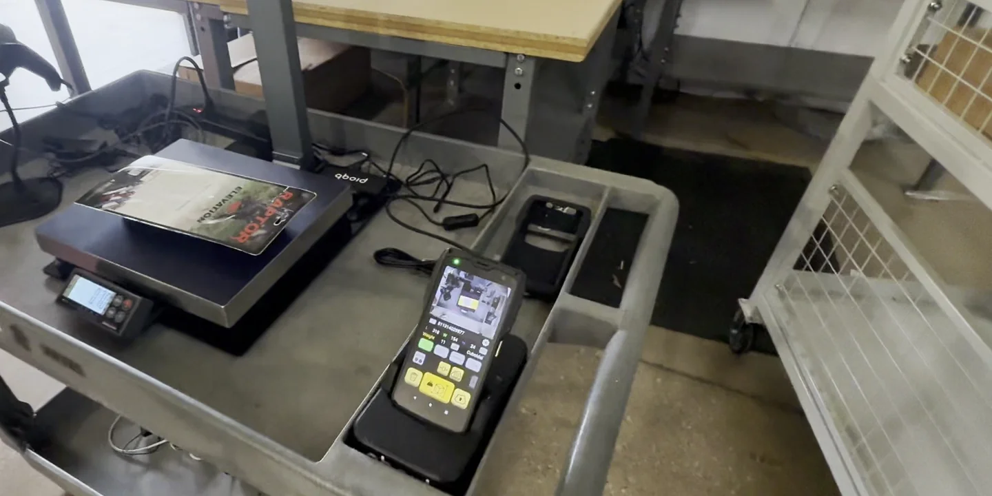 An item on the S1 scale at Weby Corp, with the M2 docked on the cart beside it showing the capture on its screen, and a barcode scanner at the left